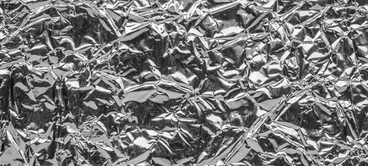 Shiny metal silver gray foil leaf crumpled texture background