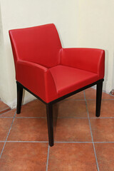 One Red Armchair at Terracotta Tiled Floor Home Interior