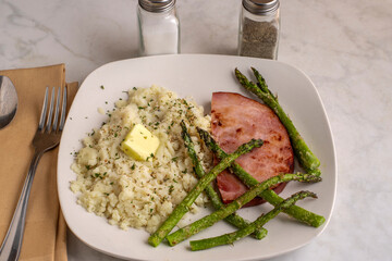 ham with asparagus and mash pot top with herbs © dmiller324