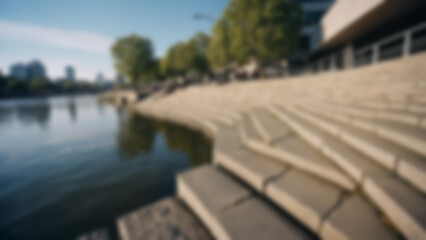 Fototapeta premium Blurred background of Public riverfront steps with stone seating, water reflections and textures, city river background, afternoon, natural sunlight.