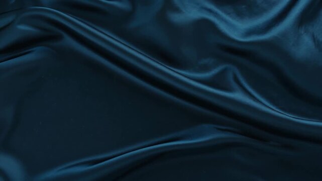 Luxurious dark teal satin fabric draped elegantly with soft waves and rich texture for backgrounds.