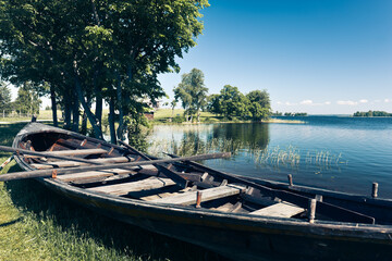 Old wooden fishing boat on the picturesque lake shore