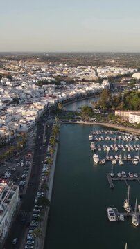 Vertical aerial panoramic view capturing Ayamonte village and harbor along the Guadiana River in Andalusia, Spain.