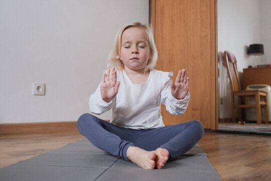 Calm child practicing mindfulness and deep breathing at home