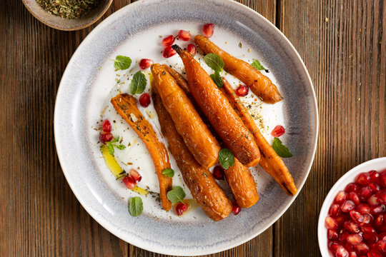Top view of whole roasted carrots cheese on plate