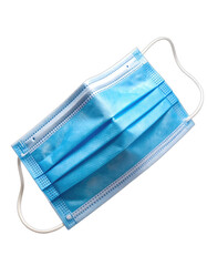 A close-up studio shot of a blue disposable surgical face mask against a solid black background.