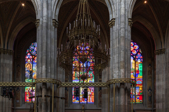 Chandelier, columns and stained glass windows in the 1879 Neo-Gothic Votivkirche (Votive Church), Vienna, Austria