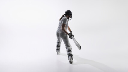 Obraz premium Female cricket batter swinging bat isolated on white background. Concept of sports marketing, athletic energy, training intensity, women empowerment and professional fitness performance advertising.