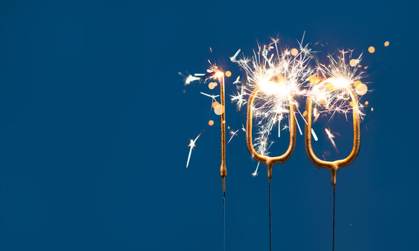 100 celebration festive background with copy space made with Bengal fires in the form of number One hundred.