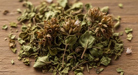 Close up of dried oregano on wooden surface for culinary and food concepts