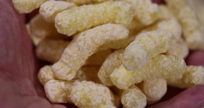 yellow large sweet sticks of corn flour with added sugar for cooking with milk or yogurt, ready-to-eat corn sticks scattered on food paper