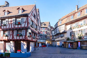 Naklejka premium Characteristic Alsatian buildings with sloping roofs and half-timbered facades, richly decorated to celebrate Christmas 