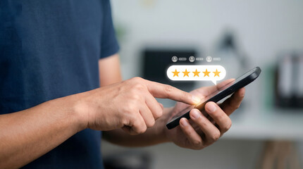 Person holds a smartphone and taps to give a five star rating on a digital screen symbolizing excellent customer satisfaction and high service quality