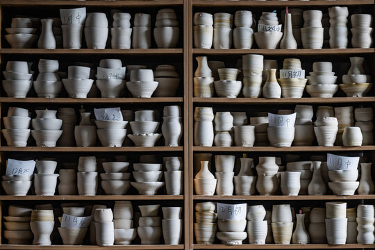 Pottery workshop interior with handmade ceramic cups on clay wheels