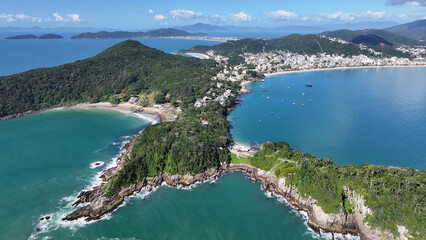 Fototapeta premium Bombinhas Beach In Bombinhas Santa Catarina Brazil. Breathtaking Aerial View Of A Lush Tropical Coastline Scenery. Shore Clouds Sky Beach Sea. Seaside Panorama. Bombinhas Santa Catarina.