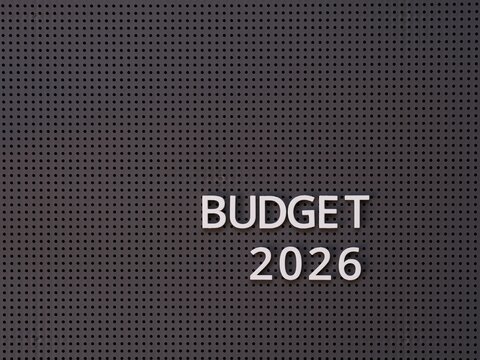Words Budget 2026 spelled out with white letters on a gray pegboard