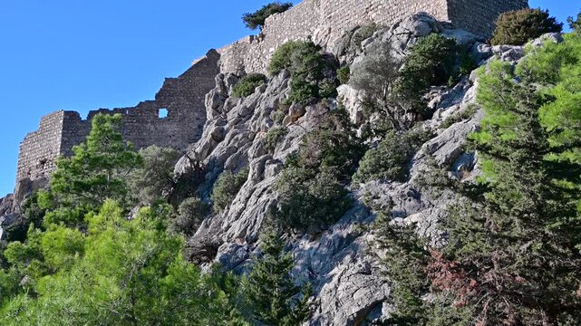 Pan Up Revealing Monolithos Castle on a Rocky Hilltop in Rhodes, Greece