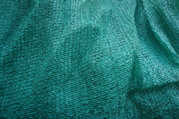 green fabric background. Shade net. Agricultural net