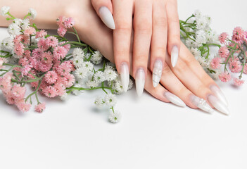 Woman showing hands with long white ombre nails © Olena Rudo