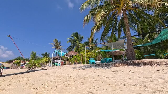 Empty white sand beach in Ukulhas Maldives with palm trees and turquoise water