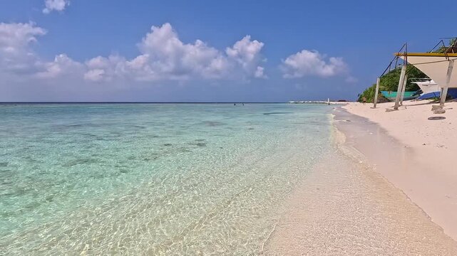 Empty white sand beach in Ukulhas Maldives with palm trees and turquoise water