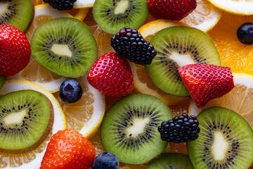 Fresh fruits arranged on a flat surface with various colors and shapes during daylight hours