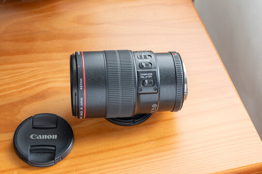 Canon ef 100mm f2.8l macro is usm lens on wood