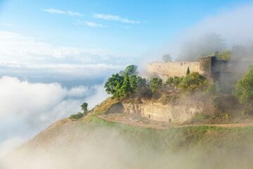 Lombardy Castle on a hilltop surrounded by misty clouds in Enna, Sicily, Italy, showcasing ancient...