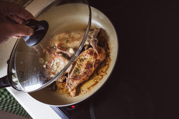 Frying meat in a pan on the stove