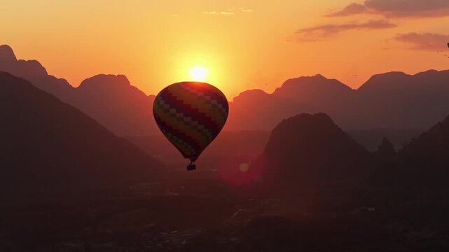 Revealing shot of Pha Tang karst mountain range and lush tropical jungle with high canopy hardwoods in Laos during a sunny day
