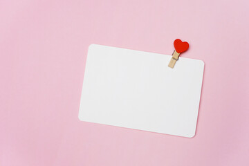 Happy Valentines day card mockup with red heart clothespin on pink paper background