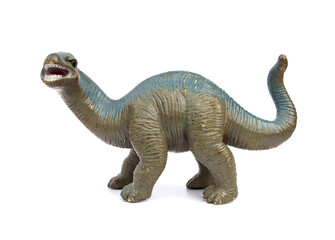 Soft plastic vintage long-necked sauropod dinosaur toy has scratches and chipped paint from old age isolated on white background. © Panupong