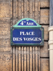 A blue plaque on the wall of an old house reads: 4th arrondissement, Place des Vosges. The Place des Vosges, originally the Place Royale (Royal Square) is the oldest planned square in Paris, France.