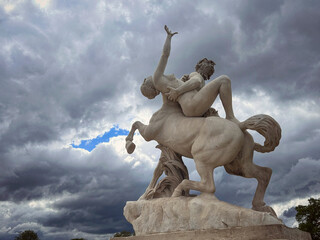 Beautiful and imposing sculpture "The centaur Nessus abducting Deianira" in the Tuileries Garden, Paris, France. Sculpture depicts a scene from Greek mythology.