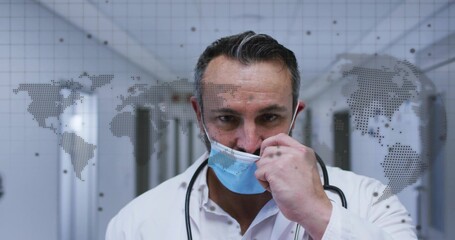 Lowering blue surgical mask, doctor in clinic corridor, with white coat, stethoscope, map overlay