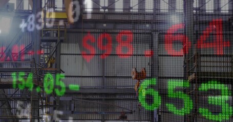 Naklejka premium Projecting translucent red and green stock numbers over industrial hall with crane hook, scaffolds