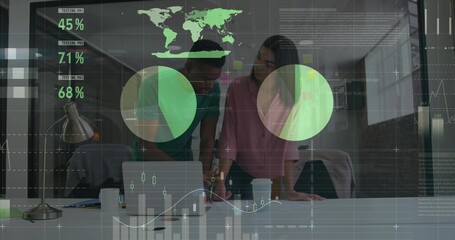 Leaning two colleagues wearing pink blouse, green shirt reviewing laptop charts at office table