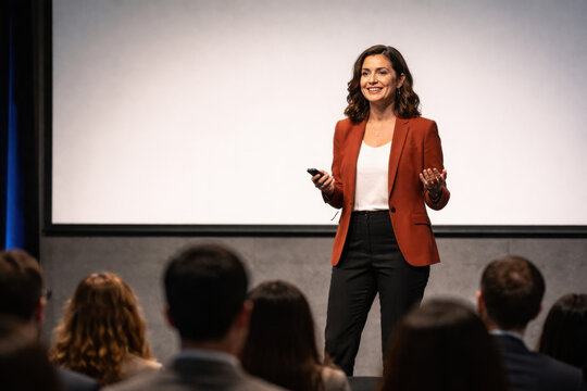 Confident Businesswoman Presenting at a Corporate Seminar or Conference Event