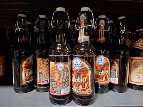 FRANKFURT AM MAIN, GERMANY - October 31, 2025.Swing top bottles of Monchshof Naturtrubes Kellerbier on a retail shelf in a German supermarket showing various labels and packaging designs
