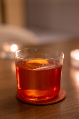 Close up view of orange cocktail on the table with bokeh background