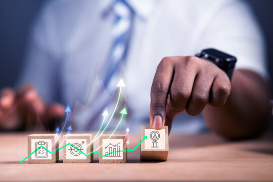 Business owners are analyzing growth using graphs that show rising spikes and percentage symbols, representing online economic growth and tax concepts.