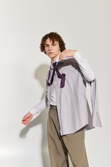 Stylish teenager showcases fashion flair in a dynamic pose against a minimalistic backdrop