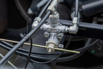 Fototapeta premium Brake system, semi-trailer brake lines, ABS system. Semi-trailer, truck spare parts. Tubes, various fasteners, and auto electronics. View on truck chassis frame equipment. Truck back parts details