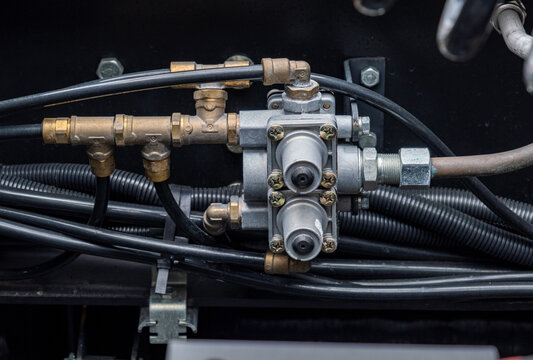 Brake system, semi-trailer brake lines, ABS system. Semi-trailer, truck spare parts. Tubes, various fasteners, and auto electronics. View on truck chassis frame equipment. Truck back parts details