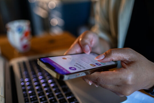 Person using mobile payment app at home office desk