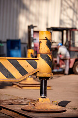 Close-up of industrial crane stabilizer leg supporting heavy machinery on construction site. Ideal for: asset management, industrial safety, load distribution, heavy equipment maintenance  