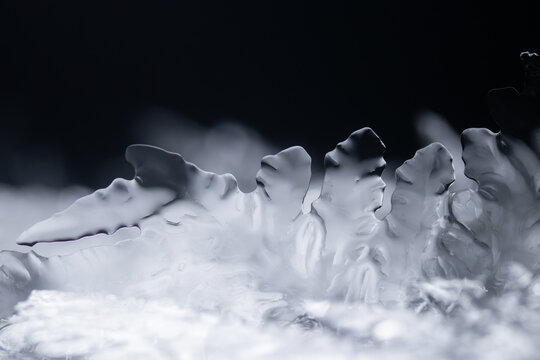 Abstract macro texture of clear ice crystals and frozen water spikes