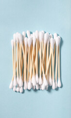 Cotton swabs with wooden sticks on blue background