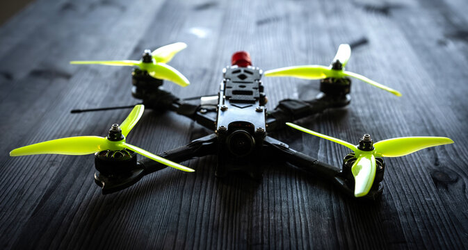 Handmade Fpv Racing Drone With A Custom Frame And Motors On A Black Table