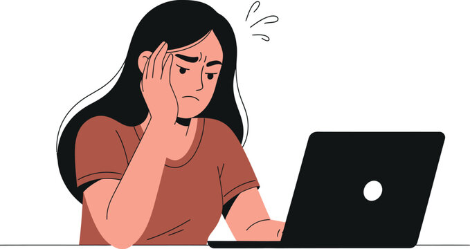 Woman sitting at a laptop looking puzzled or confused